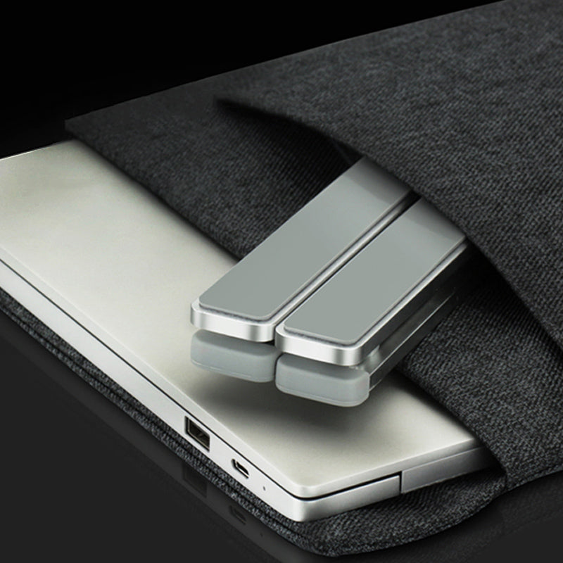 Metallic laptop stand on a black surface