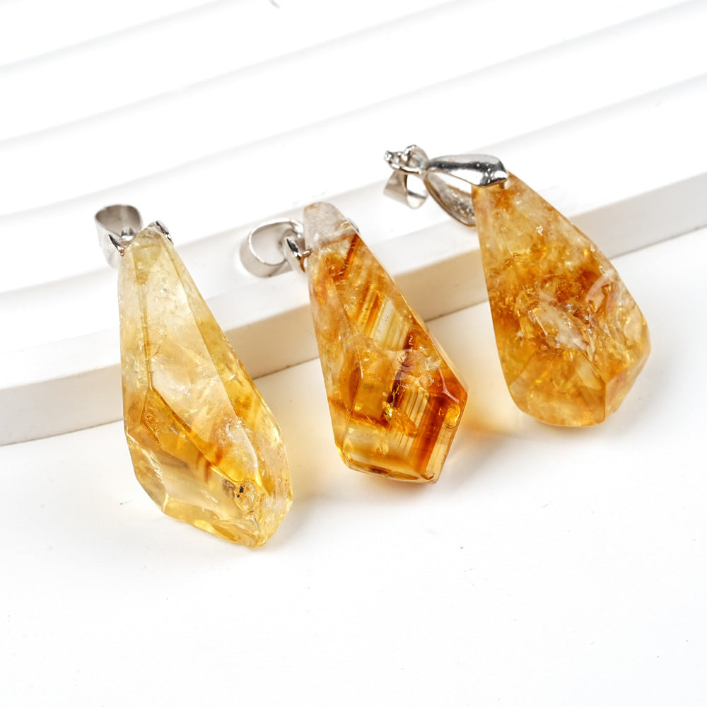 Three amber-colored teardrop-shaped earrings on a white background