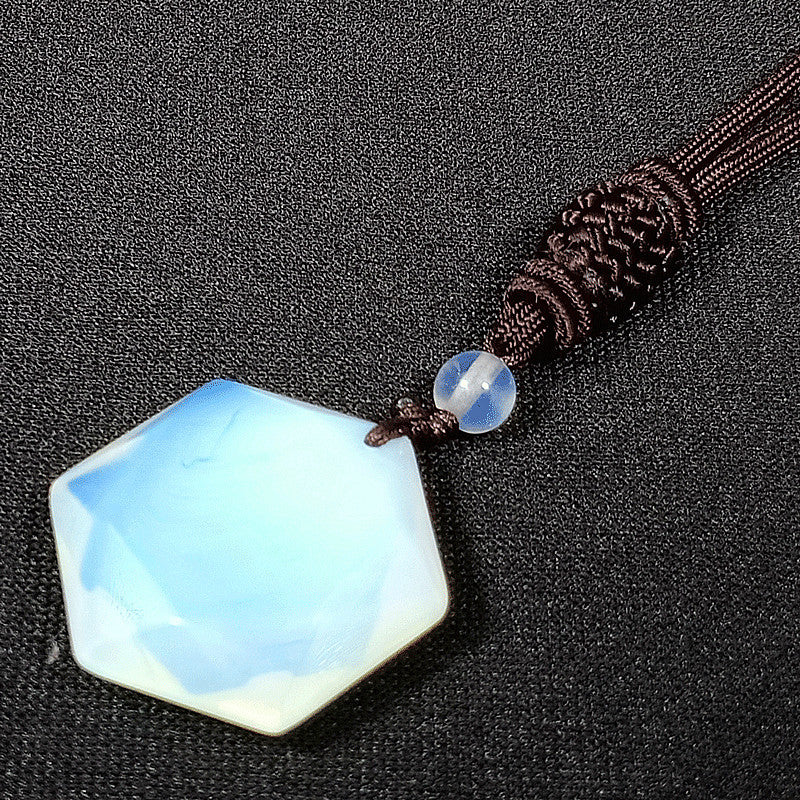 Necklace with a faceted blue pendant on a dark background
