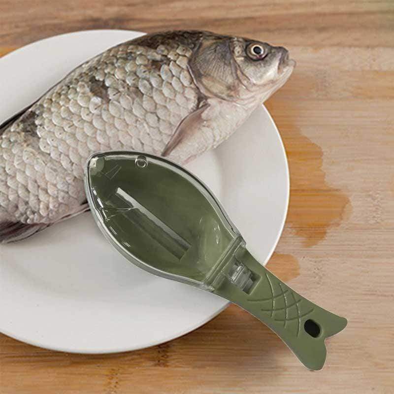 Green fish-shaped tool on a white plate with a whole fish