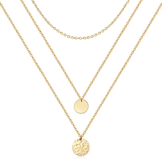 Two gold necklaces with round pendants on a white background