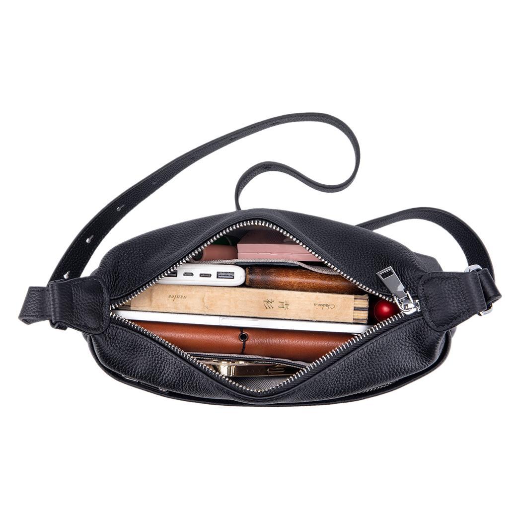 Black leather crossbody bag with interior compartments on a white background