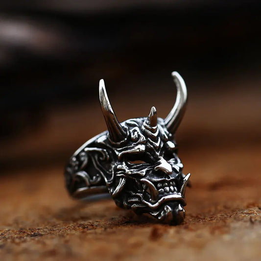 Silver dragon head ring on a wooden surface