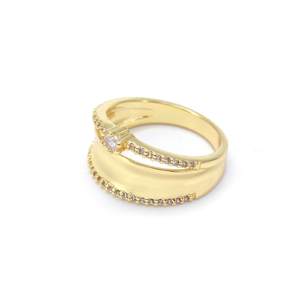 Gold ring with embedded diamonds on a white background