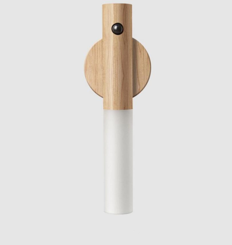 White cylindrical object with wooden top on a light gray background