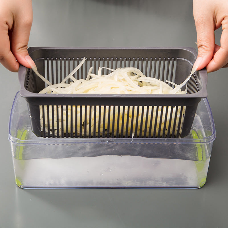 Person using a vegetable chopper to shred onions on a gray background