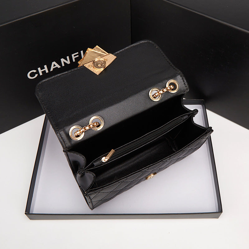 Black wallet with gold accents on a white box, featuring the Chanel logo.