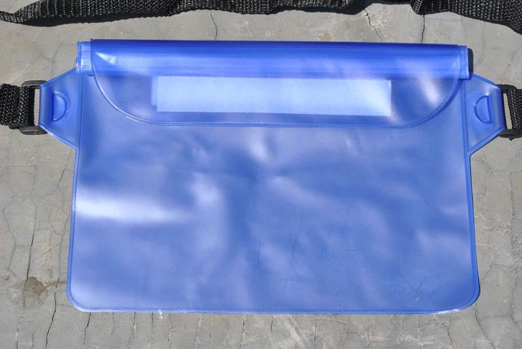 Blue waterproof bag with a strap on a gray surface