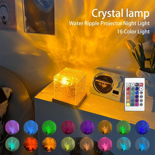 Crystal lamp with water ripple projector night light on a table, surrounded by decorative items.