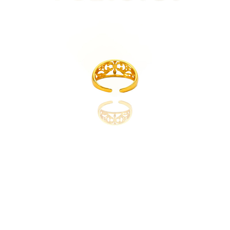 Gold ring with intricate design on a white background