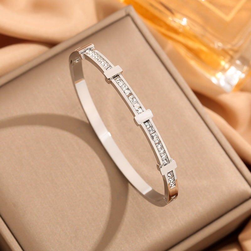 Silver bracelet with small diamonds on a beige box
