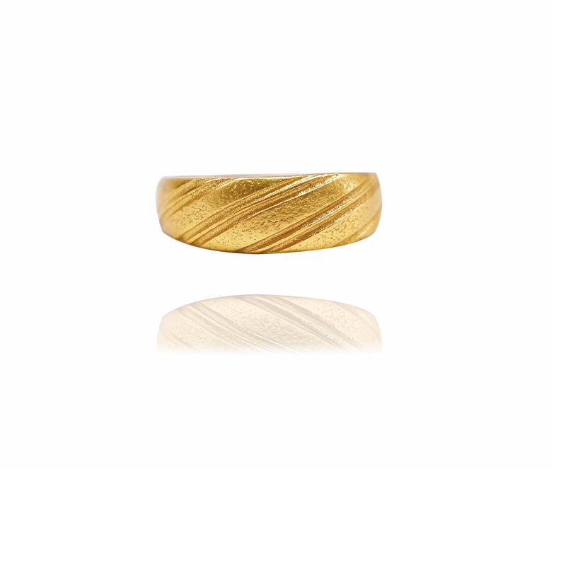 Gold ring with marbled texture on a white background