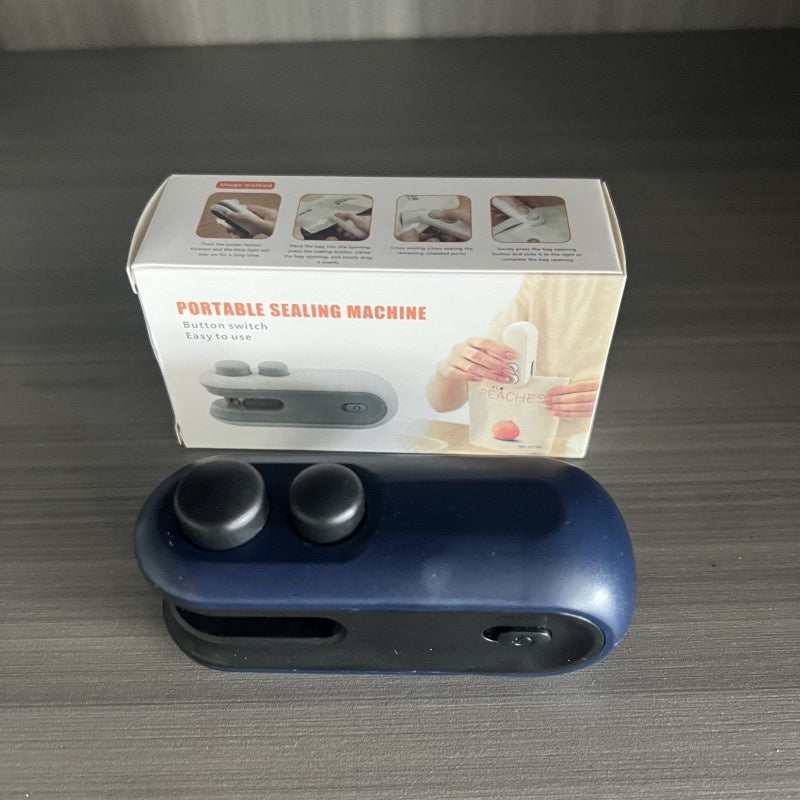Blue portable sealing machine with packaging on a gray surface