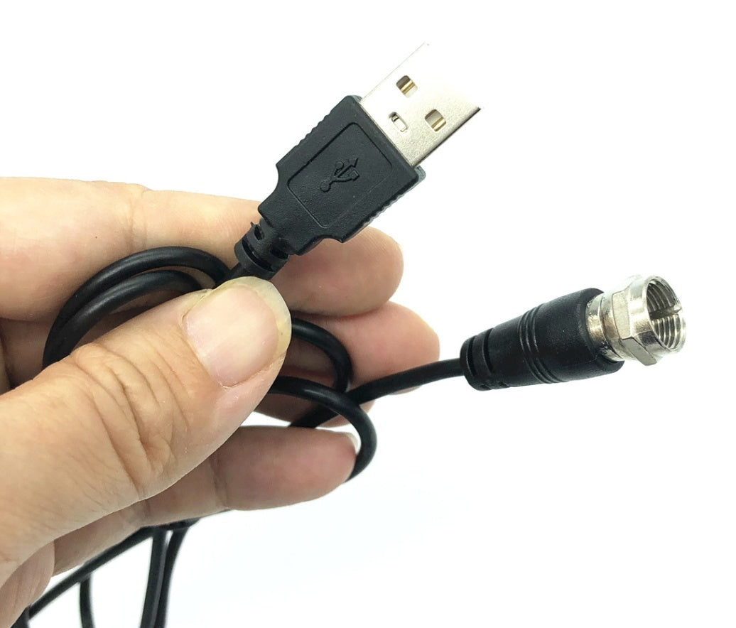 Hand holding a cable with USB and BNC connectors on a white background