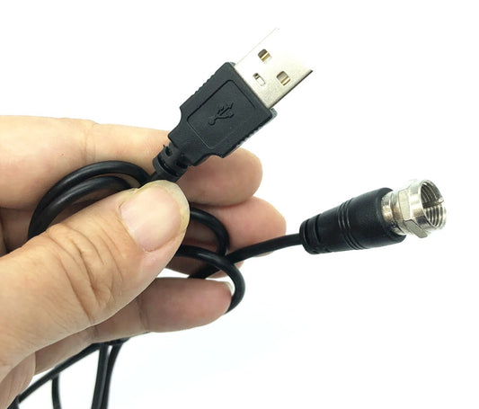 Hand holding a cable with USB and BNC connectors on a white background