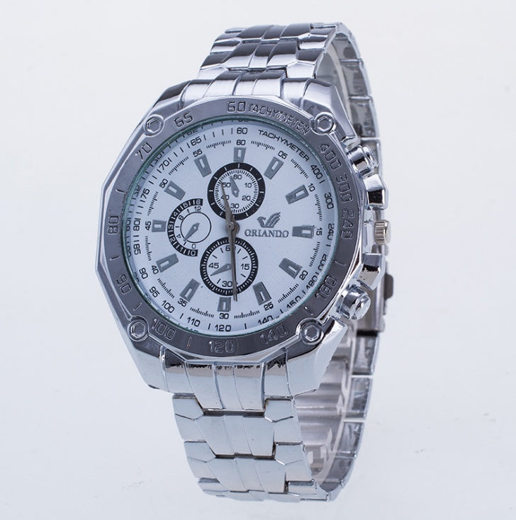 Silver wristwatch with a detailed face on a light gray background