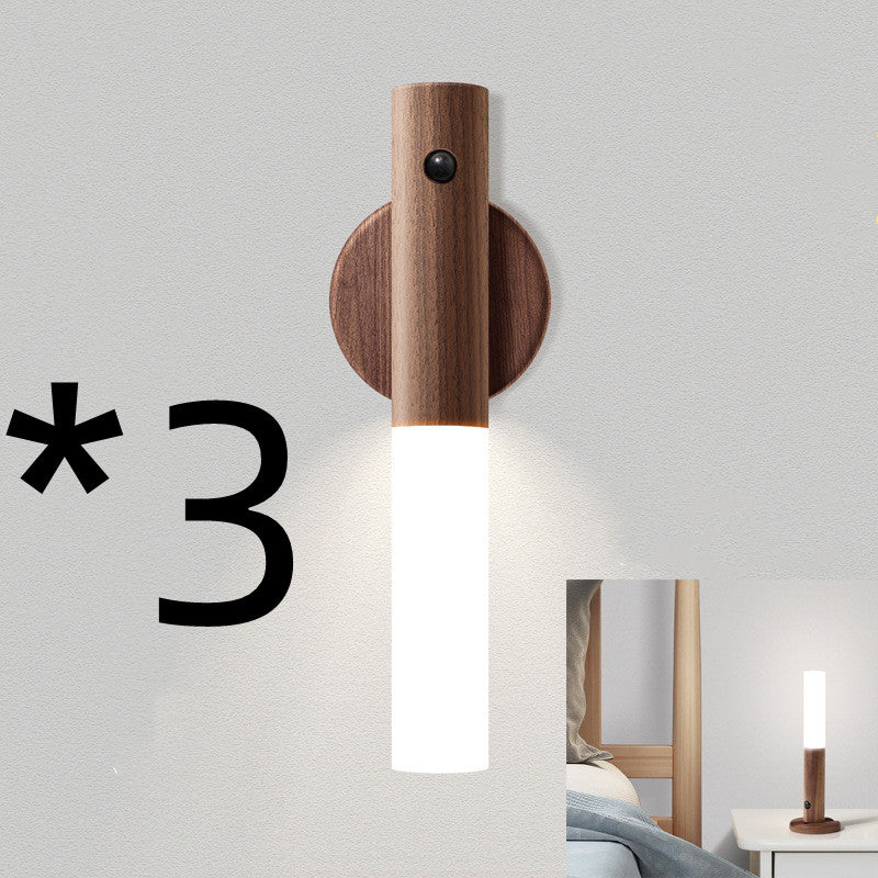 Wooden wall sconce with a white light bulb on a gray wall.