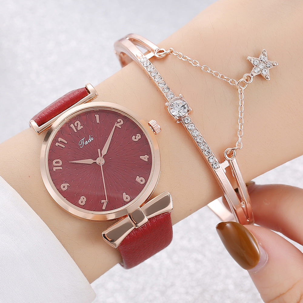 Wrist with red watch and bracelet on a light background