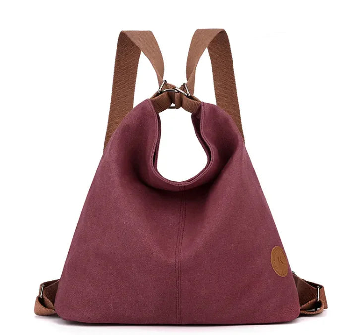 Maroon backpack with brown straps on a white background