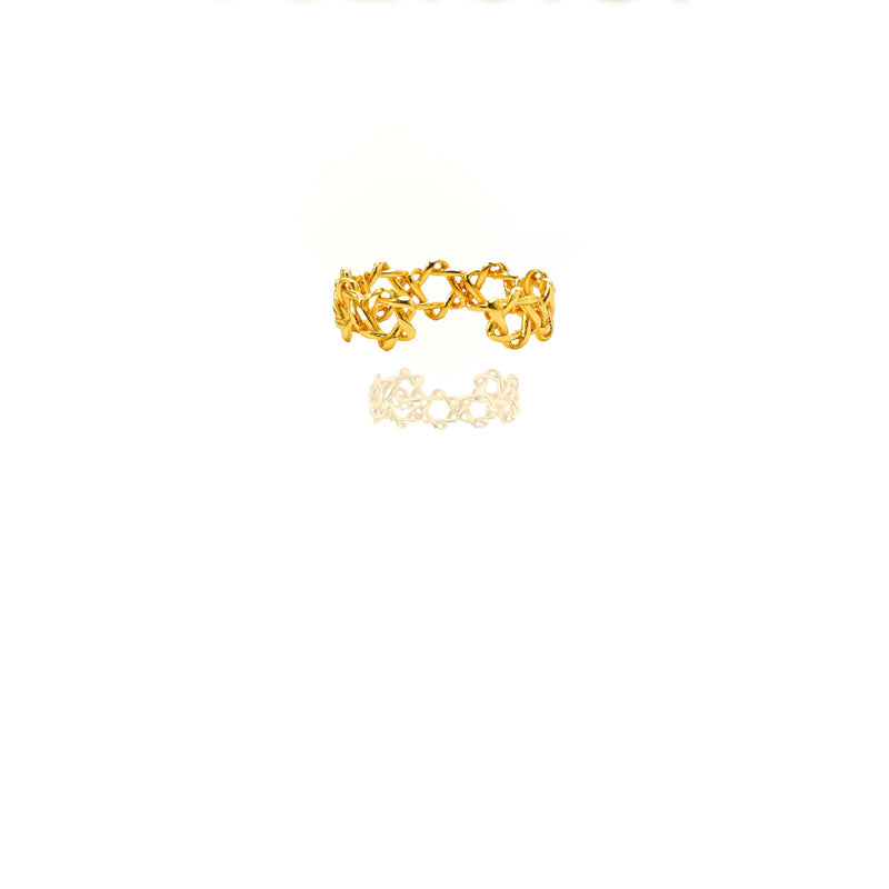 Gold ring with intricate design on a white background