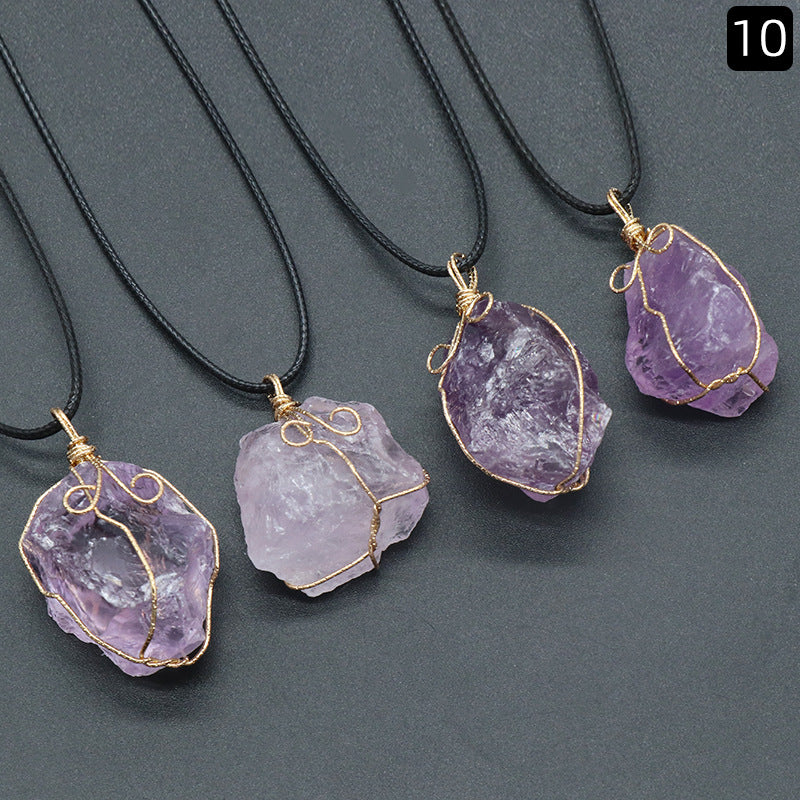 Purple crystal pendants on black cords against a gray background