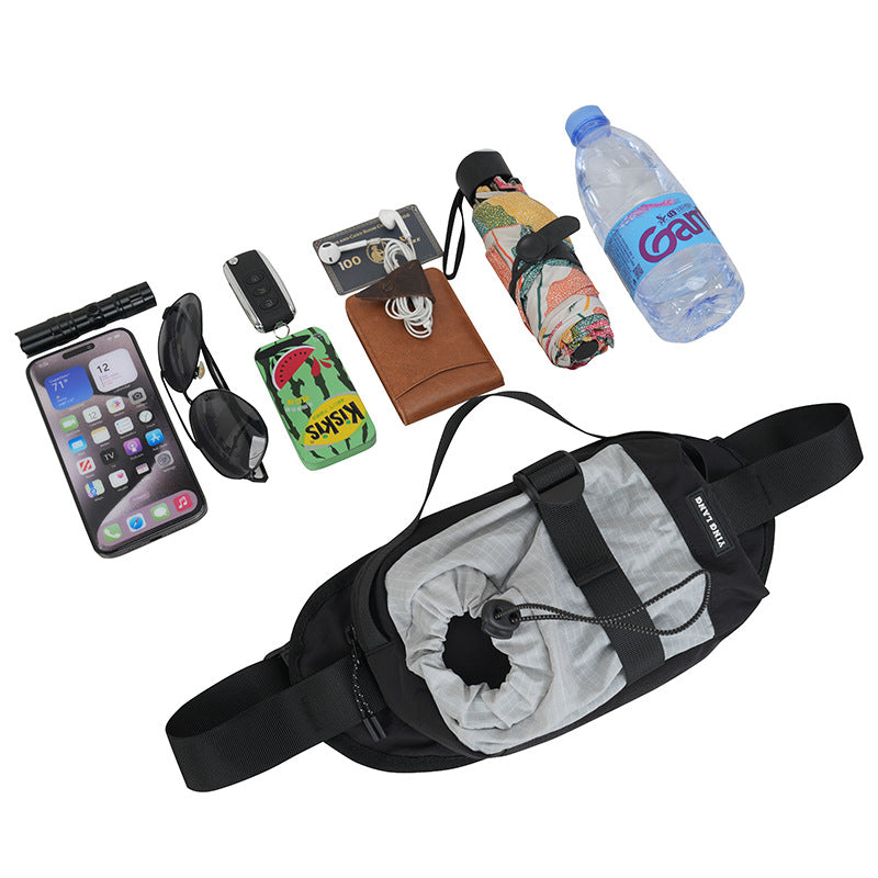 Fanny pack with phone, sunglasses, wallet, umbrella, and water bottle on a white background