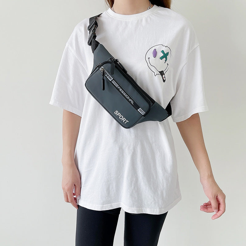 Person wearing a white t-shirt with a graphic design and carrying a black crossbody bag.