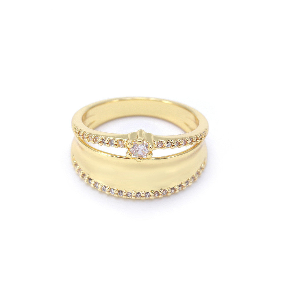 Gold ring with a diamond on a white background