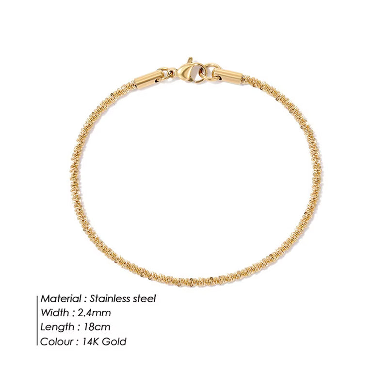 Gold bracelet with specifications on a white background