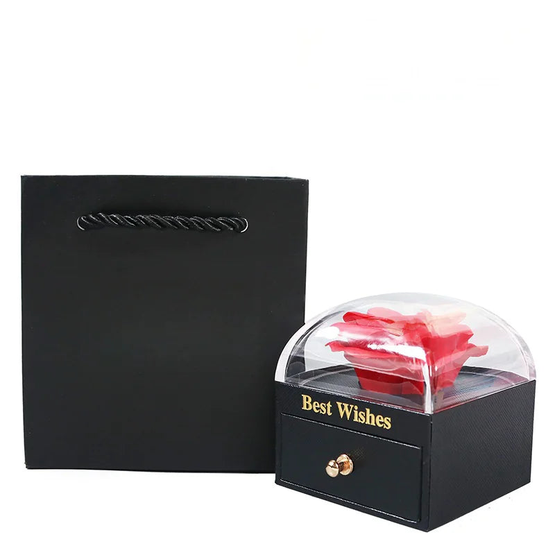 Black gift box with a red rose inside, labeled 'Best Wishes', on a white background.
