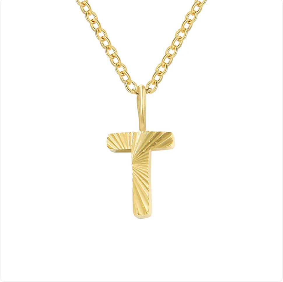 Gold cross necklace on a white background