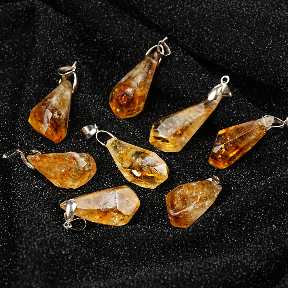 Teardrop-shaped amber pendants on a black background