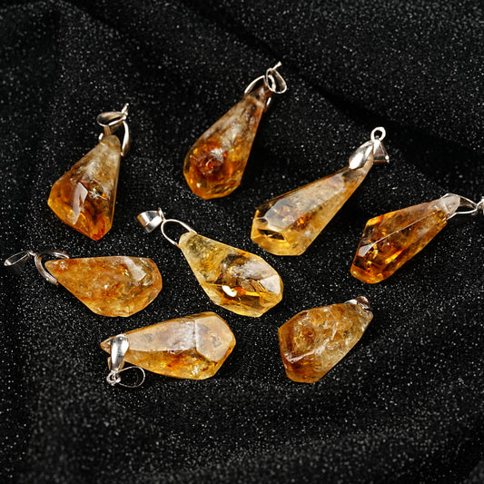Teardrop-shaped amber pendants on a black background