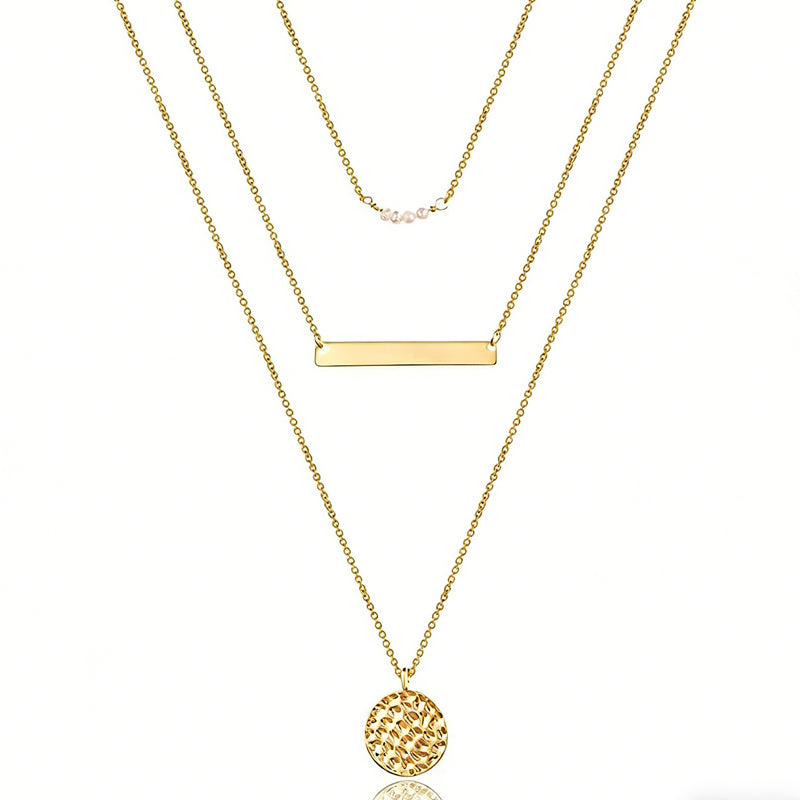 Three gold necklaces with different pendants on a white background