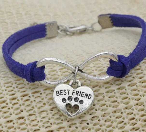 Bracelet with purple cord and silver 'Best Friend' charm on a textured beige background