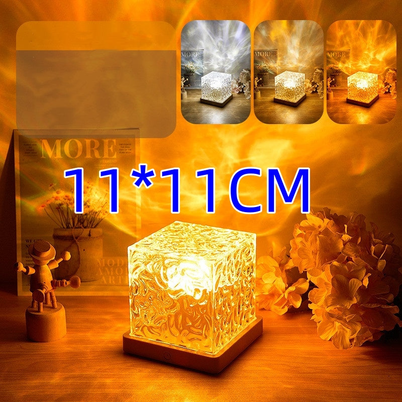 Decorative glass cube light on a wooden surface with floral decorations and text indicating size.