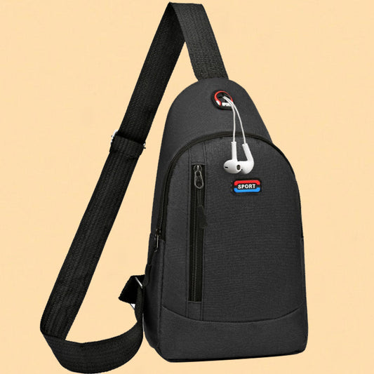 Black sling bag with earbuds attached on a beige background