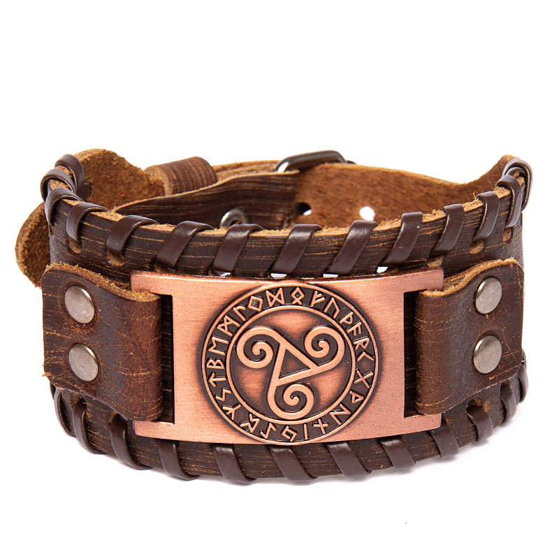 Brown leather bracelet with bronze emblem featuring Celtic design on a white background