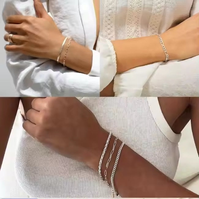 Close-up of hands wearing gold and silver bracelets on a white background