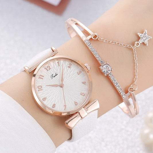 Rose gold watch and bracelet on a wrist with a white background