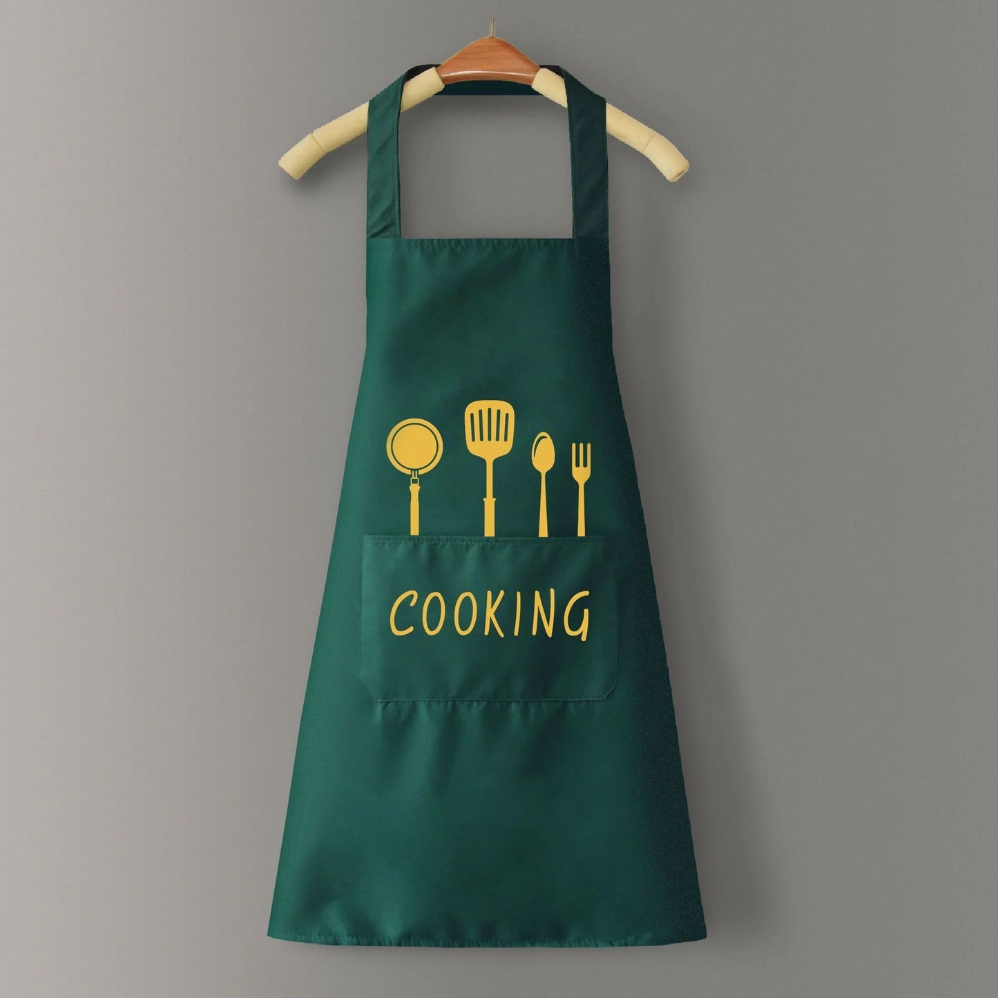Green apron with yellow cooking utensil icons and 'COOKING' text on a gray background