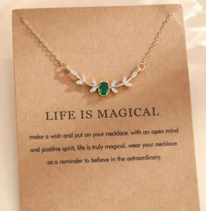 Necklace with green gemstone on a 'Life is Magical' card