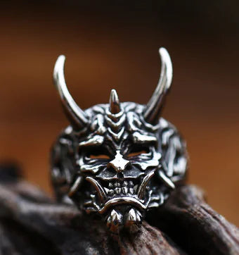Silver ring with a dragon design on a wooden surface