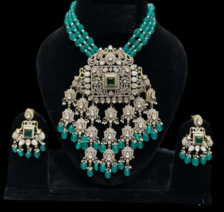 Turquoise and silver jewelry set on a black stand