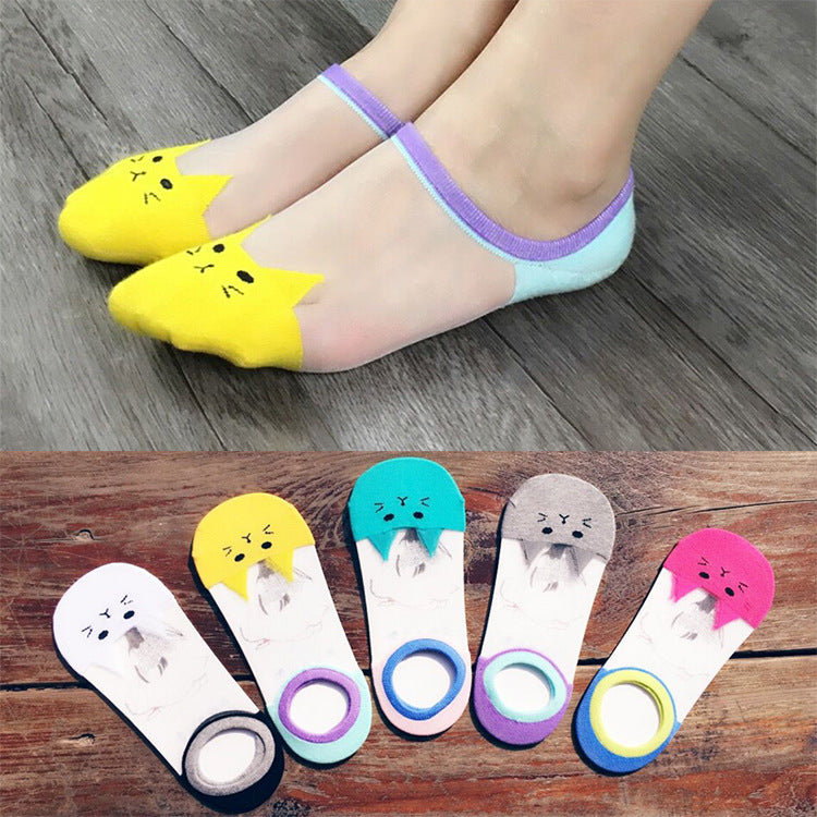Transparent socks with cartoon designs on a wooden surface