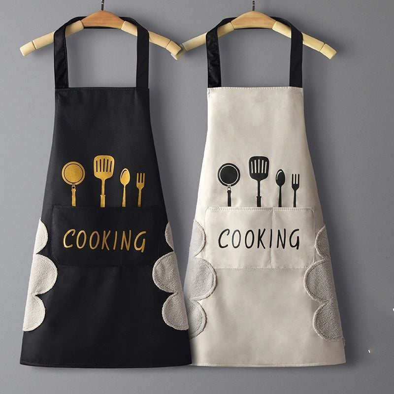 Two aprons, one black and one beige, with cooking utensil designs and 'COOKING' text on a gray background.