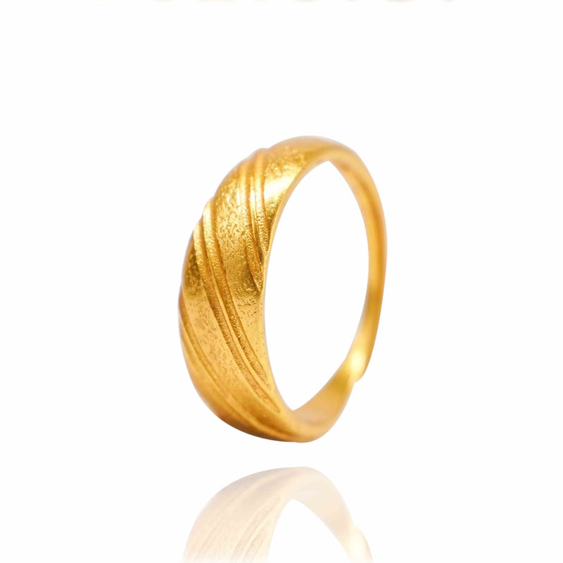 Gold ring with a textured design on a white background