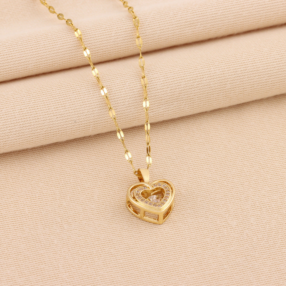 Gold heart-shaped necklace on a beige fabric background