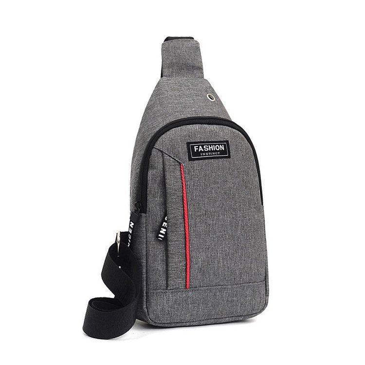 Gray crossbody bag with a red zipper on a white background