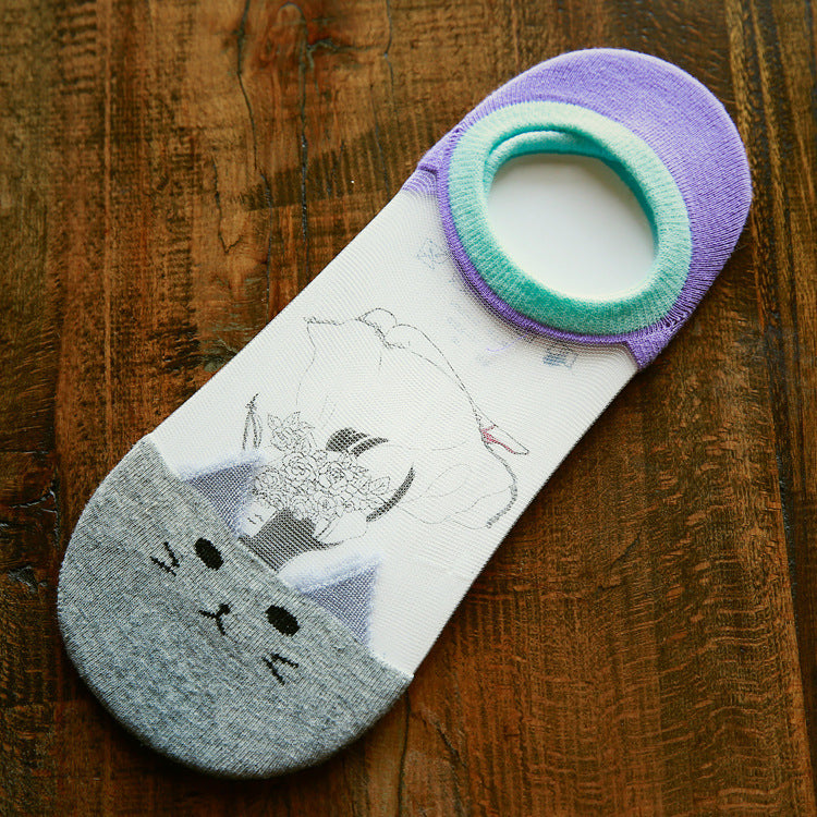 Cat-themed sock with a gray cat design on a wooden surface